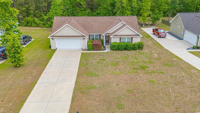 ranch-style home with a front lawn, concrete driveway, and an attached garage