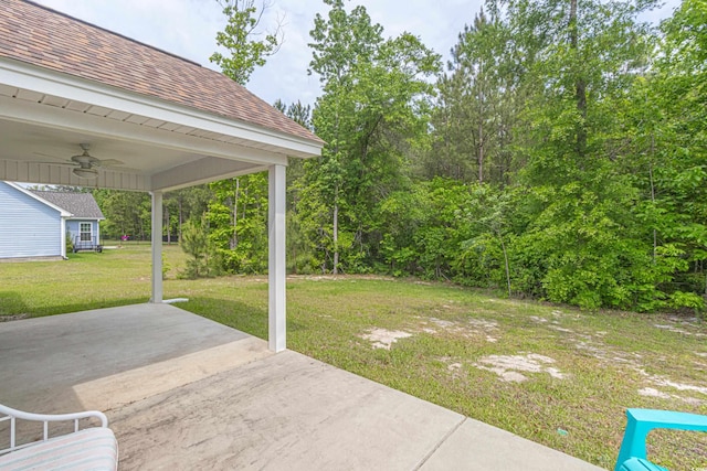 view of yard with a patio and ceiling fan