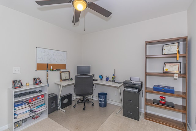 office space with baseboards and a ceiling fan