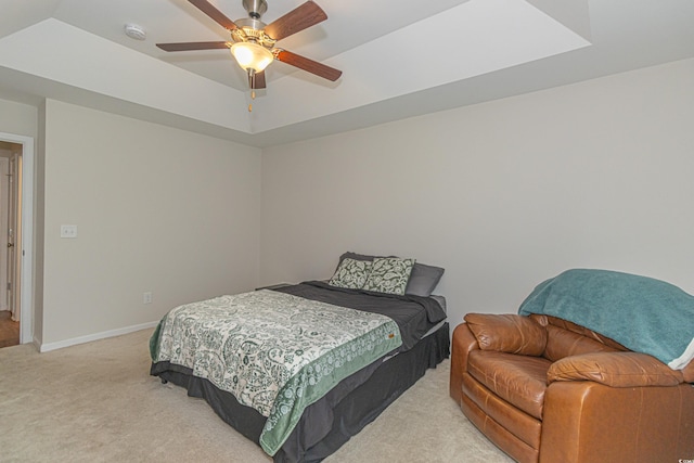 bedroom with baseboards, ceiling fan, and light colored carpet
