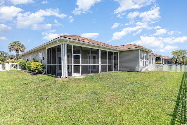 197 Northside Dr, Little River, SC 29566 - back of property featuring a fenced backyard, a yard, a sunroom, and a tile roof