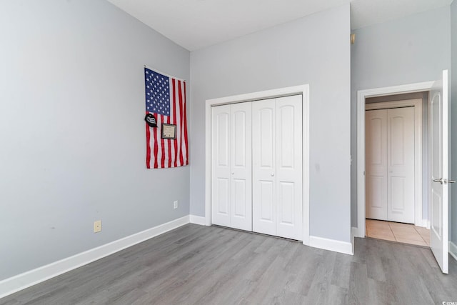 197 Northside Dr, Little River, SC 29566 - unfurnished bedroom featuring wood finished floors, a closet, and baseboards