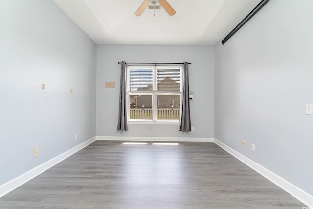 197 Northside Dr, Little River, SC 29566 - spare room with wood finished floors, a ceiling fan, and baseboards