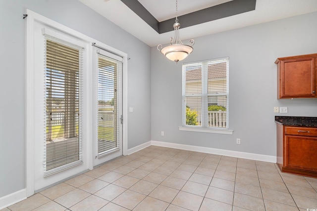 197 Northside Dr, Little River, SC 29566 - unfurnished dining area featuring baseboards, a raised ceiling, and a healthy amount of sunlight
