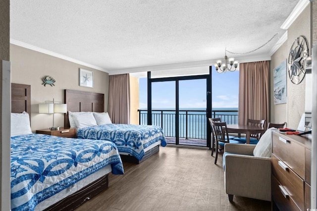 6900 Ocean Blvd N Unit 1114, Myrtle Beach, SC 29572 - bedroom featuring a textured ceiling, a water view, access to outside, a chandelier, and ornamental molding