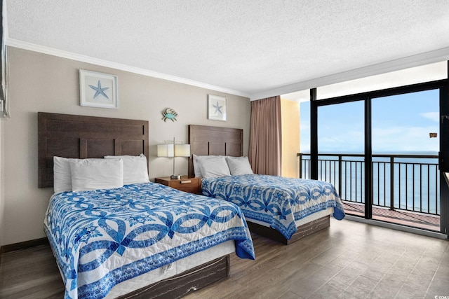 6900 Ocean Blvd N Unit 1114, Myrtle Beach, SC 29572 - bedroom featuring access to exterior, a textured ceiling, ornamental molding, wood finished floors, and floor to ceiling windows
