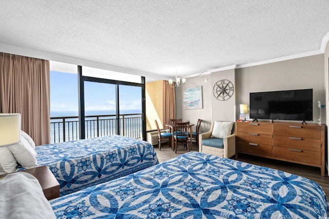 6900 Ocean Blvd N Unit 1114, Myrtle Beach, SC 29572 - bedroom featuring access to outside, a chandelier, a textured ceiling, crown molding, and multiple windows