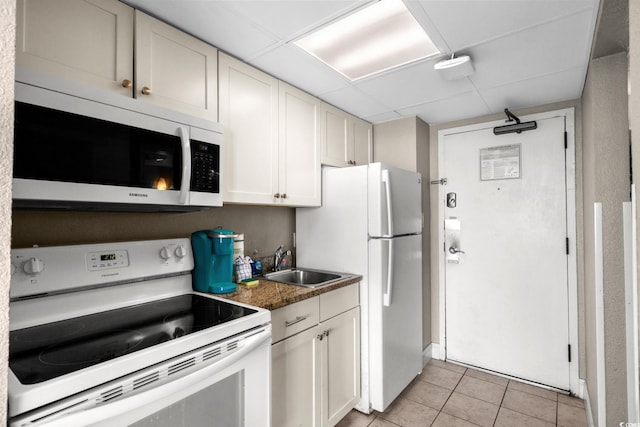 6900 Ocean Blvd N Unit 1114, Myrtle Beach, SC 29572 - kitchen with white appliances, light tile patterned flooring, a drop ceiling, and white cabinets