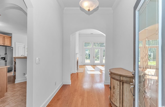 178 Kessinger Dr, Surfside Beach, SC 29575 - hallway with arched walkways, french doors, ornamental molding, light wood-style flooring, and baseboards