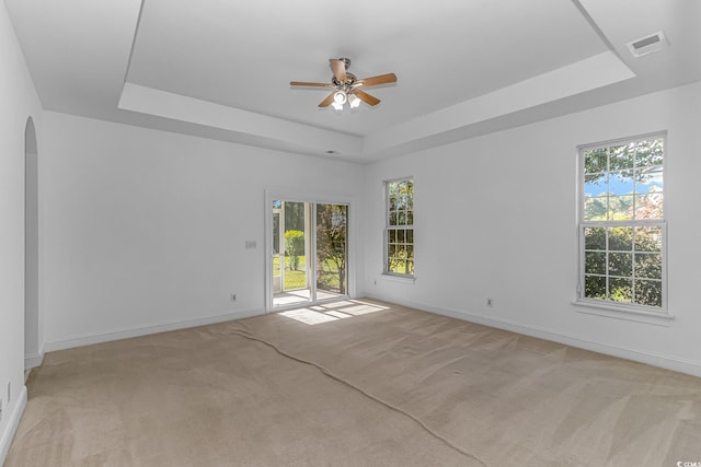 178 Kessinger Dr, Surfside Beach, SC 29575 - unfurnished room with a raised ceiling, arched walkways, a ceiling fan, light colored carpet, and healthy amount of natural light