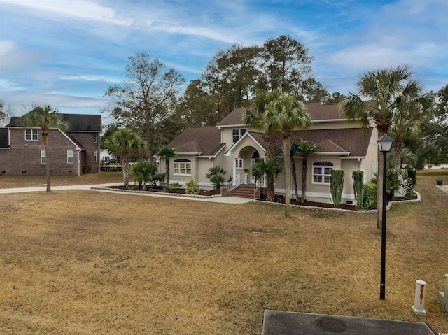 view of front of home featuring a front lawn and stucco siding