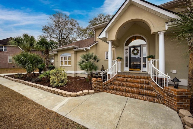 doorway to property with stucco siding