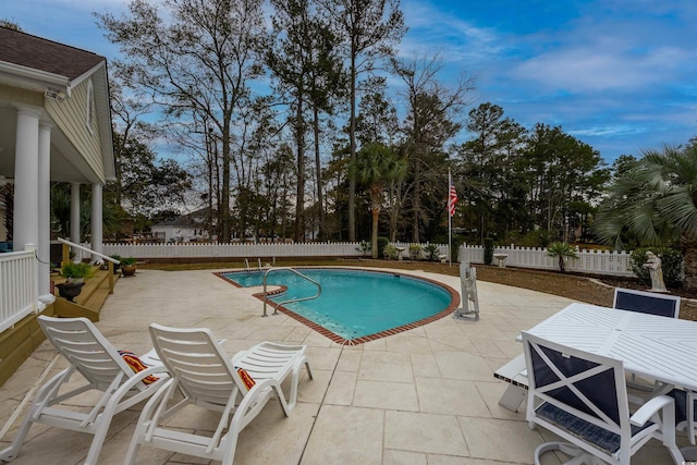 view of pool with a fenced in pool, outdoor dining space, a fenced backyard, and a patio area