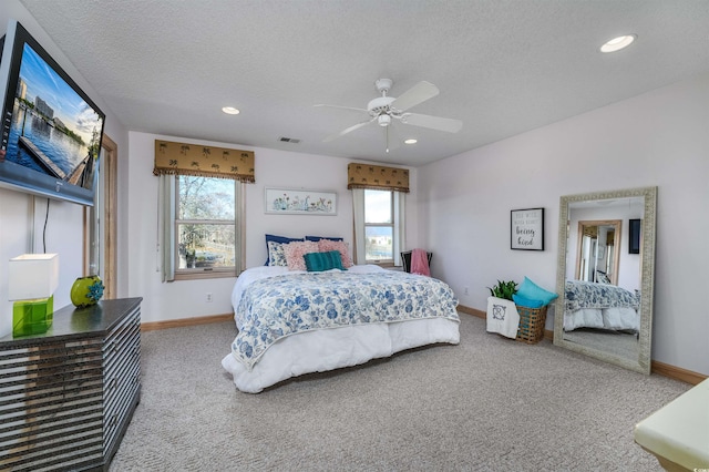 bedroom with carpet floors, visible vents, and multiple windows