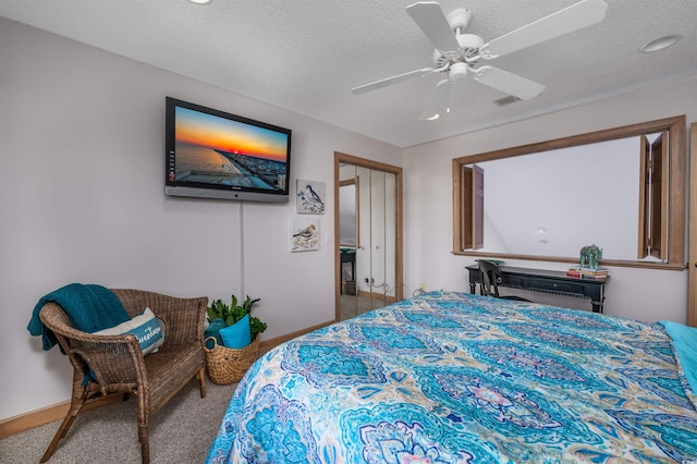 bedroom with a ceiling fan, a textured ceiling, visible vents, baseboards, and carpet