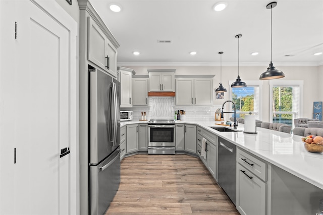 kitchen featuring a sink, stainless steel appliances, gray cabinets, visible vents, and light wood finished floors