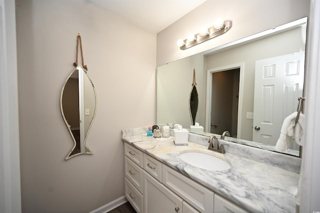 bathroom featuring baseboards and vanity