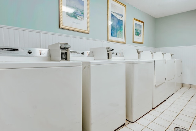7100 N Ocean Blvd Unit 801, Myrtle Beach, SC 29572 - shared laundry room featuring washing machine and clothes dryer, wainscoting, and light tile patterned floors