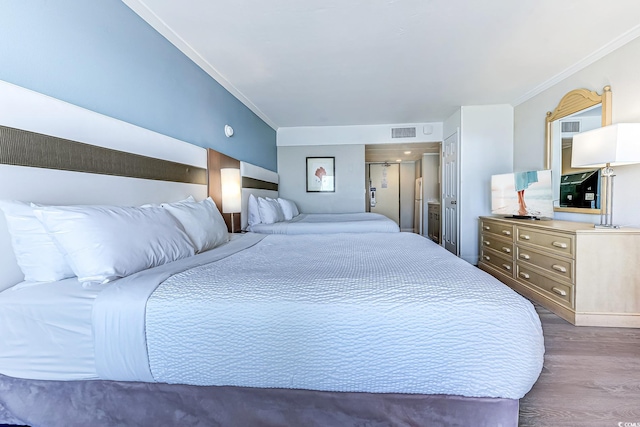7100 N Ocean Blvd Unit 801, Myrtle Beach, SC 29572 - bedroom with dark wood-type flooring and crown molding