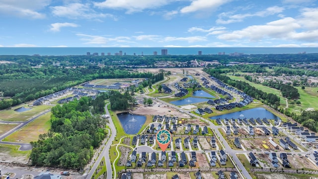 aerial overview of property's location featuring a nearby body of water and nearby urban area