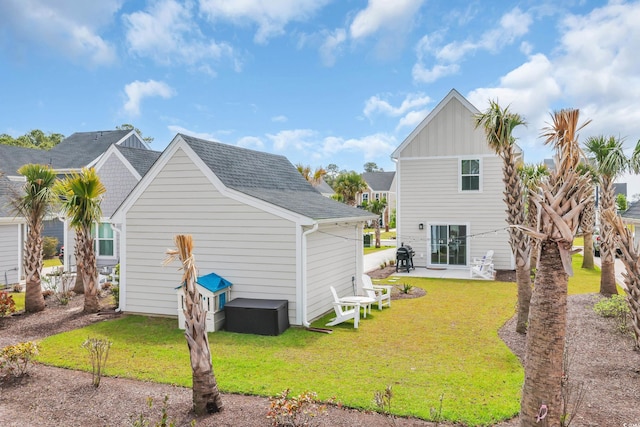 view of side of home with a yard, board and batten siding, and a patio