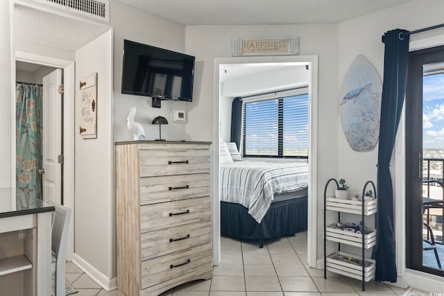 bedroom with light tile patterned floors and visible vents