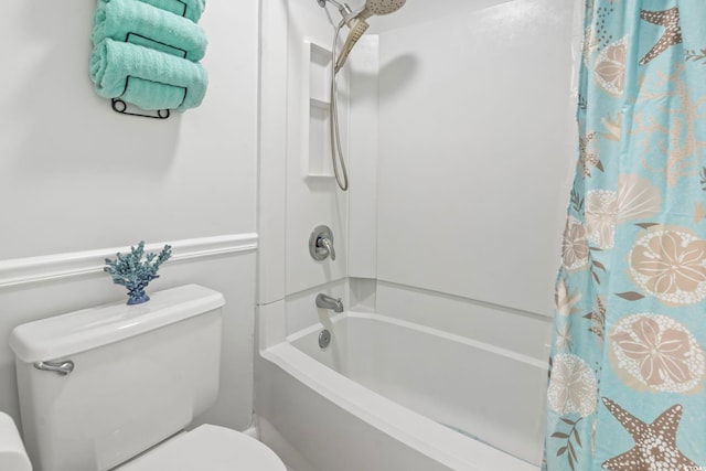 bathroom featuring toilet and shower / tub combo with curtain