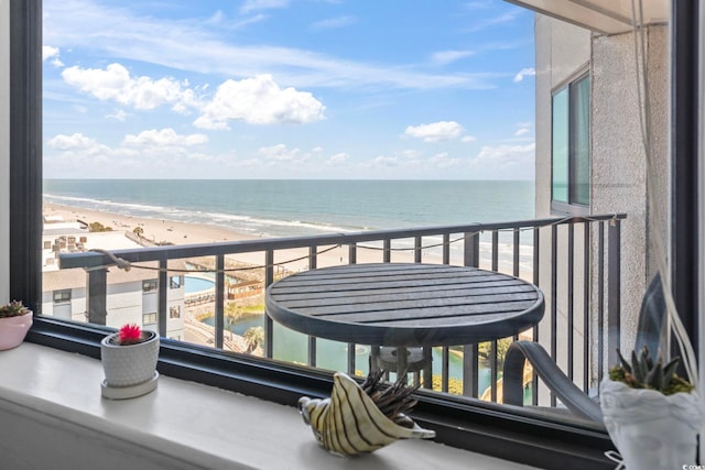 balcony featuring a water view and a view of the beach