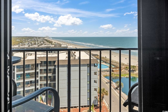 balcony with a water view and a beach view