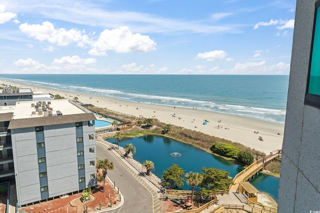 birds eye view of property featuring a water view and a view of the beach