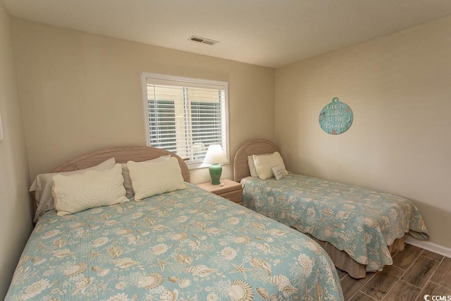 201 Landing Rd Unit D, North Myrtle Beach, SC 29582 - bedroom with baseboards, visible vents, and wood finish floors