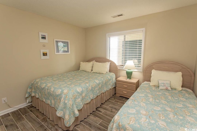 201 Landing Rd Unit D, North Myrtle Beach, SC 29582 - bedroom with wood finish floors, visible vents, and baseboards