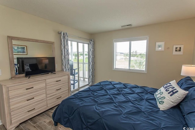 201 Landing Rd Unit D, North Myrtle Beach, SC 29582 - bedroom featuring wood finished floors, visible vents, and access to outside