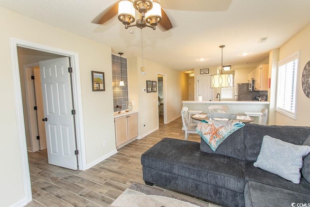 201 Landing Rd Unit D, North Myrtle Beach, SC 29582 - living room with baseboards, visible vents, a ceiling fan, and light wood-style flooring