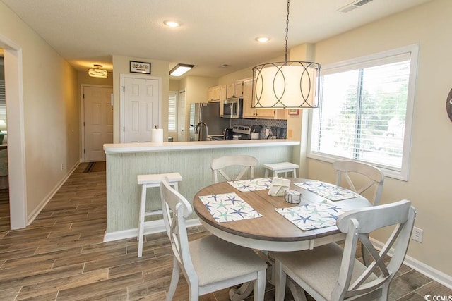 201 Landing Rd Unit D, North Myrtle Beach, SC 29582 - dining space with baseboards, recessed lighting, dark wood-style flooring, and plenty of natural light