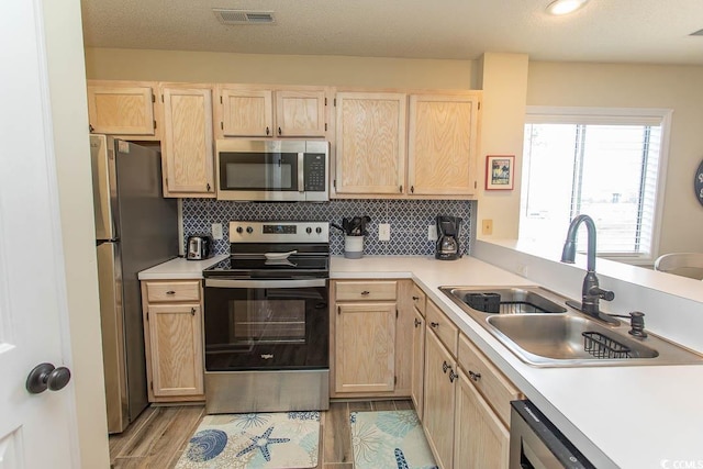201 Landing Rd Unit D, North Myrtle Beach, SC 29582 - kitchen featuring light brown cabinetry, a sink, stainless steel appliances, and visible vents