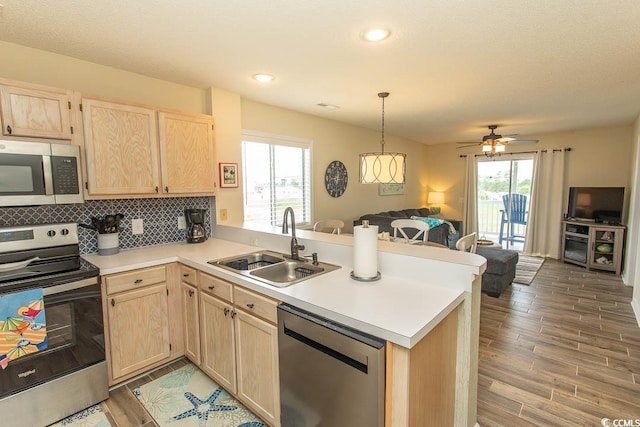 201 Landing Rd Unit D, North Myrtle Beach, SC 29582 - kitchen featuring a sink, open floor plan, stainless steel appliances, and light brown cabinets