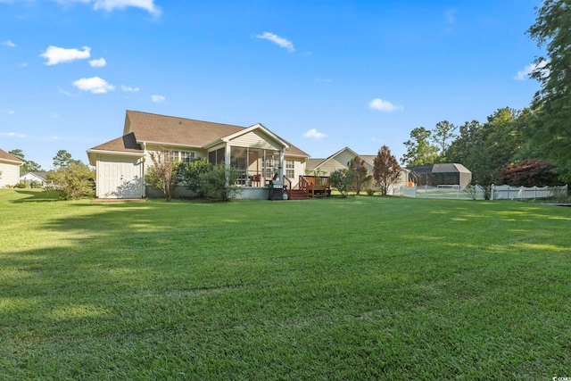 view of yard with fence and a sunroom