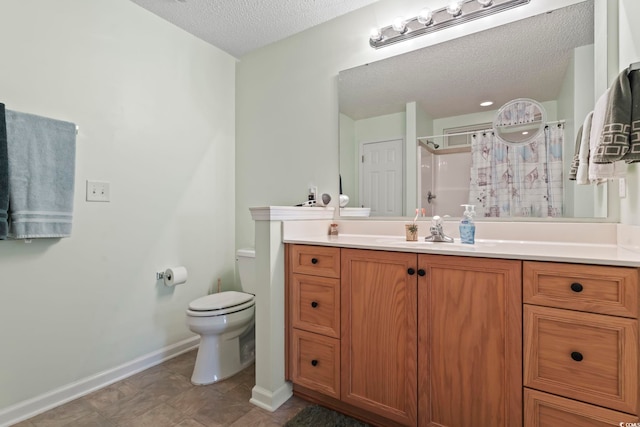 full bath featuring a textured ceiling, walk in shower, vanity, baseboards, and toilet