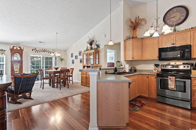 kitchen with electric range, black microwave, a sink, a chandelier, and a peninsula