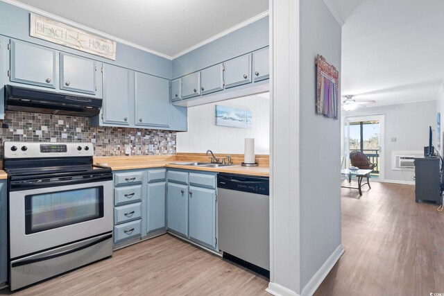 9501 Shore Dr Unit B-316, Myrtle Beach, SC 29572 - kitchen with under cabinet range hood, appliances with stainless steel finishes, a sink, and light wood-style floors