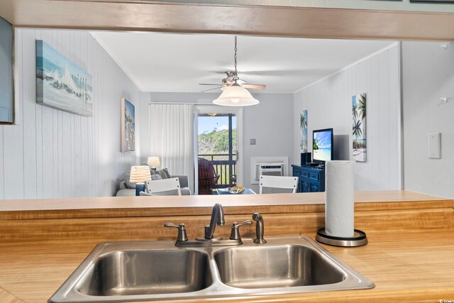 9501 Shore Dr Unit B-316, Myrtle Beach, SC 29572 - kitchen featuring ceiling fan, open floor plan, ornamental molding, and a sink