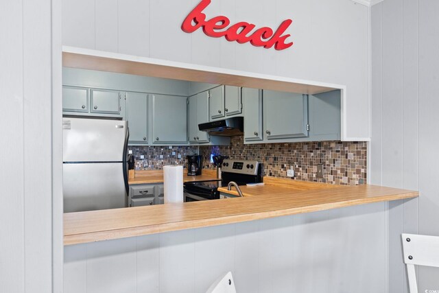 9501 Shore Dr Unit B-316, Myrtle Beach, SC 29572 - kitchen with backsplash, under cabinet range hood, stainless steel appliances, and light countertops