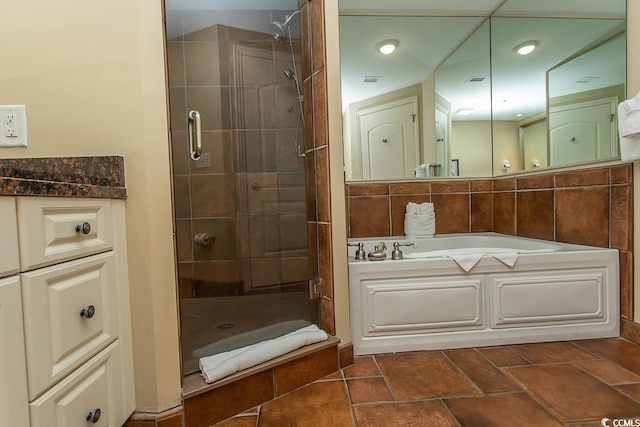 bathroom featuring a shower stall and a bath