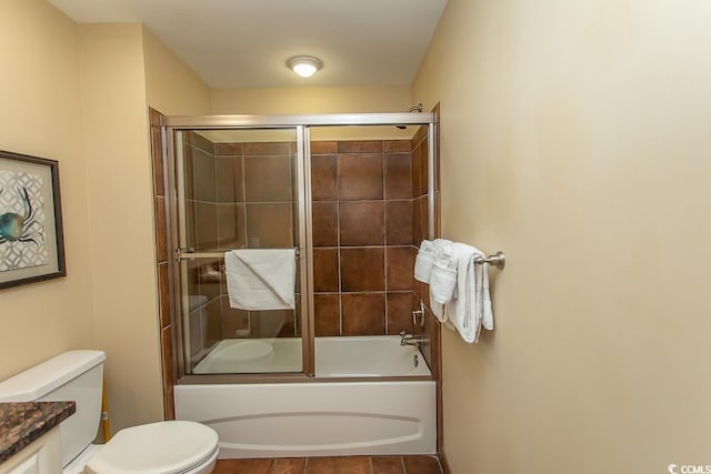 bathroom with toilet, shower / bath combination with glass door, and vanity