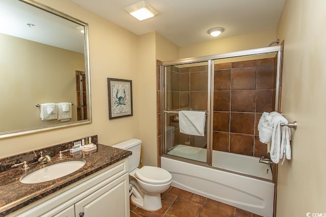 bathroom with vanity, bath / shower combo with glass door, and toilet
