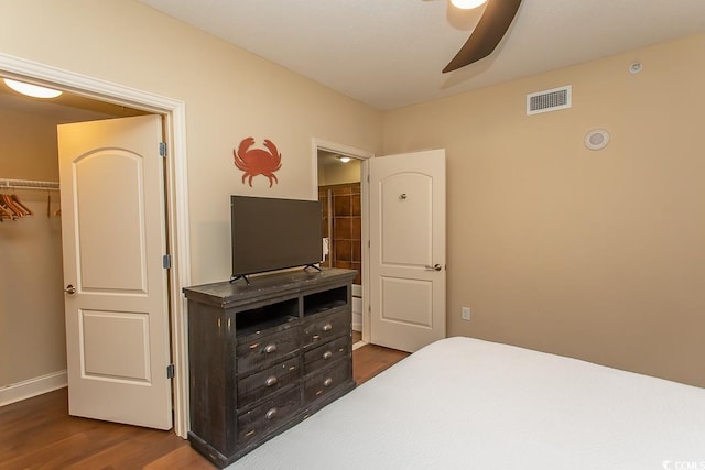 bedroom featuring dark wood-type flooring, ceiling fan, and visible vents