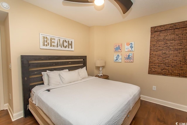 bedroom featuring baseboards, a ceiling fan, and dark wood-style floors