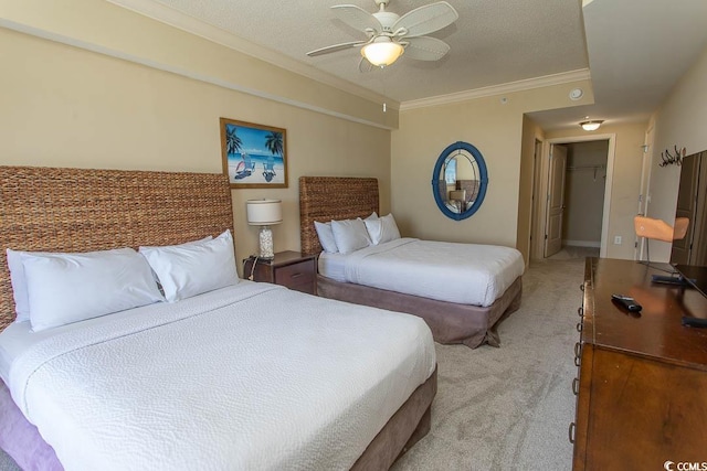 100 N Beach Blvd Unit 1801, North Myrtle Beach, SC 29582 - bedroom with a walk in closet, ceiling fan, light colored carpet, a closet, and ornamental molding