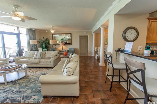 100 N Beach Blvd Unit 1801, North Myrtle Beach, SC 29582 - living room with crown molding, decorative columns, baseboards, a textured ceiling, and a ceiling fan